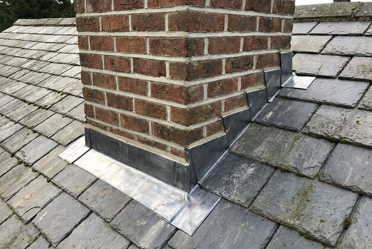 Chimney with new leadwork on a house roof